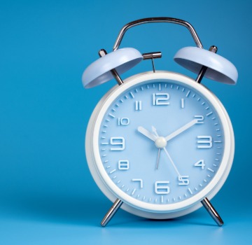Blue wall and a blue alarm clock